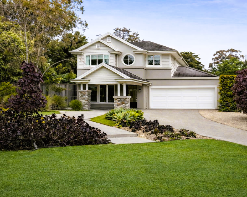 Stylish two-story house with a well-maintained lawn and driveway.